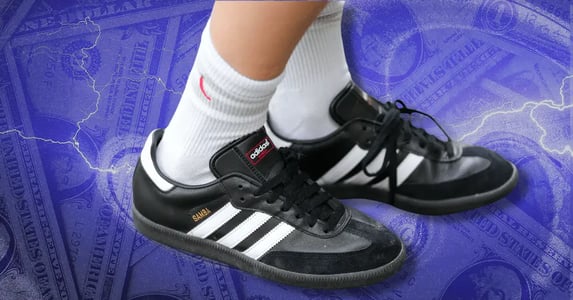 Feet wearing black Adidas Sambas with white ankle socks.